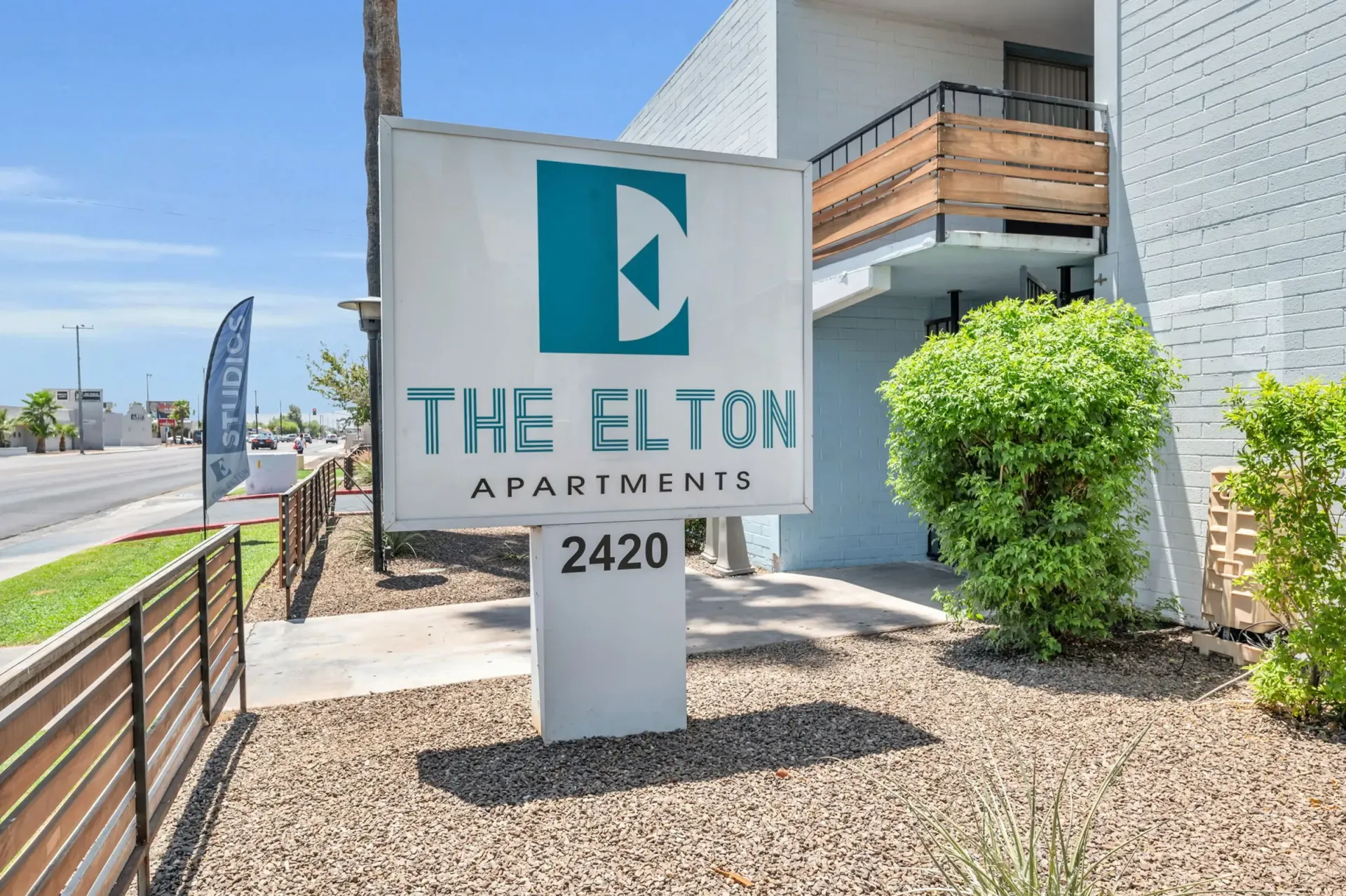 a sign for the elton apartments sits in front of a building