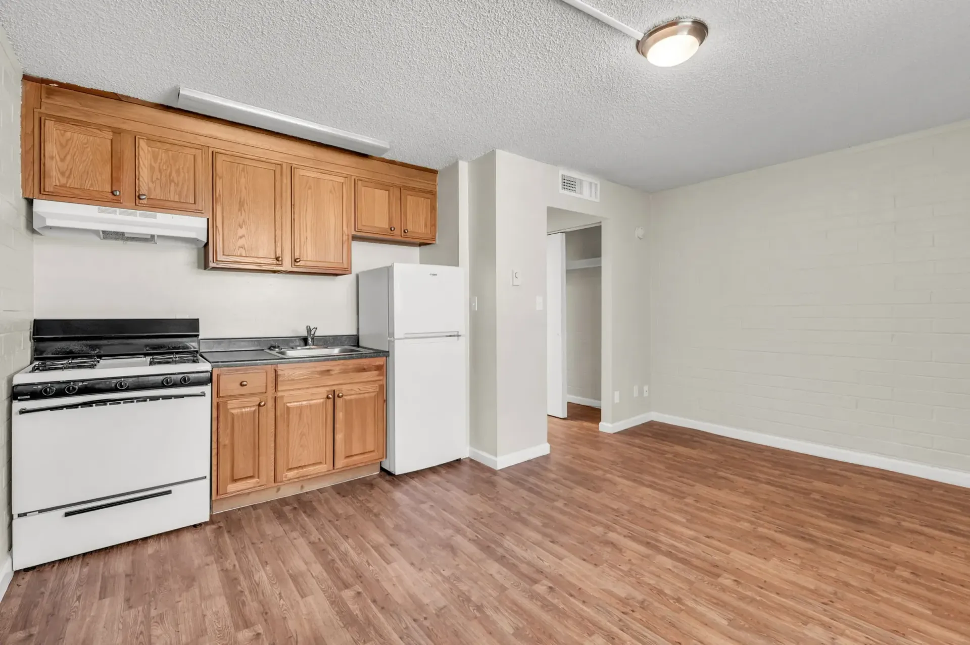 a kitchen with wooden cabinets and a white refrigerator
