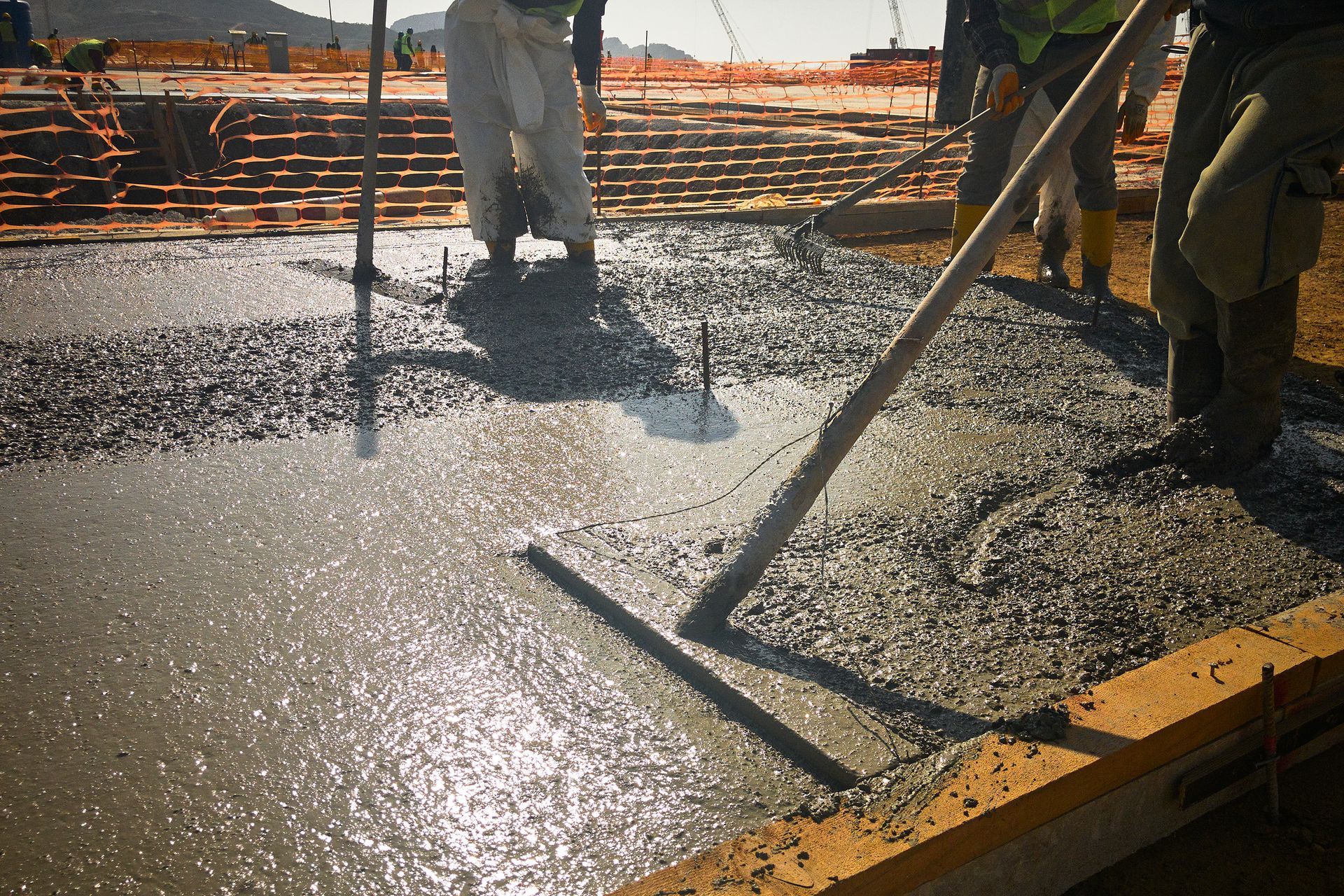 A Worker Is Spreading Concrete With A Rake | Penrith, NSW | Johnson's Concrete