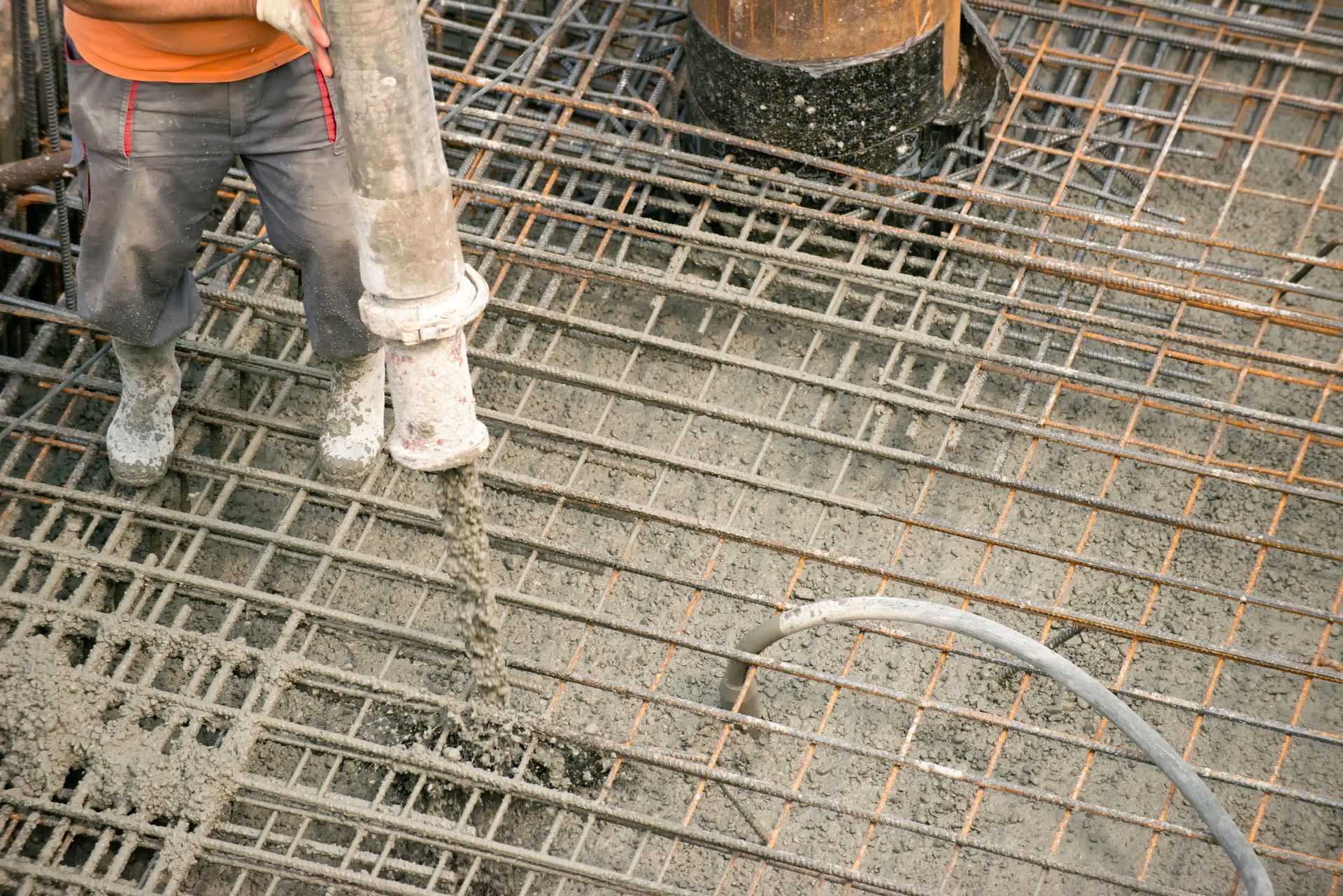 A Person Is Pouring Concrete Into a Steel Structure | Penrith, NSW | Johnson's Concrete