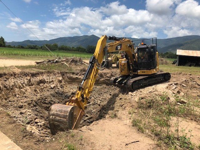 Excavator Digging Hole — Builders in Ingham, QLD