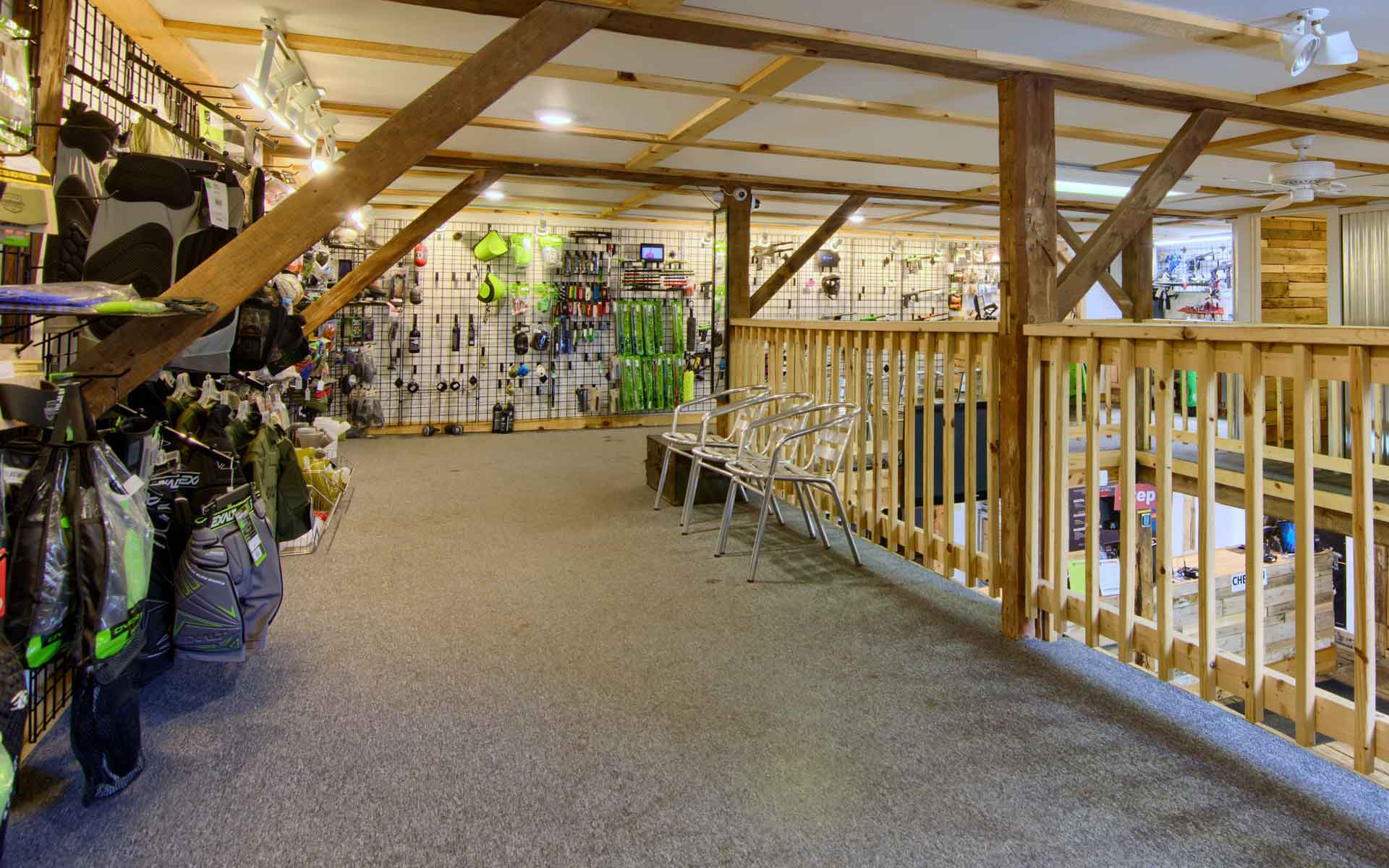 Indoor view of sporting goods store with a second story railing.