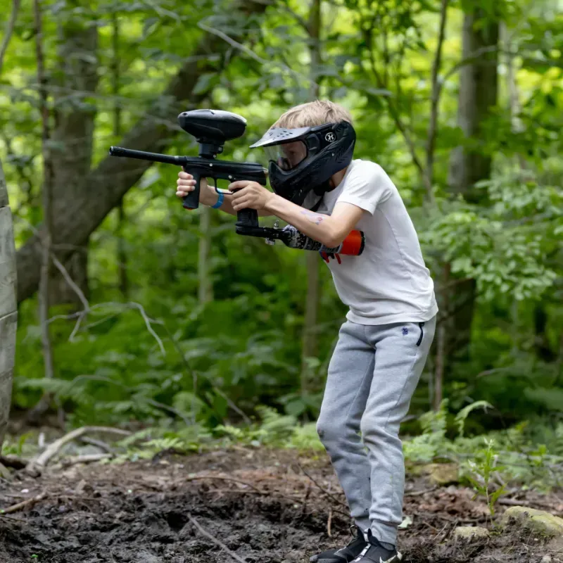 Boy playing low impact paintball