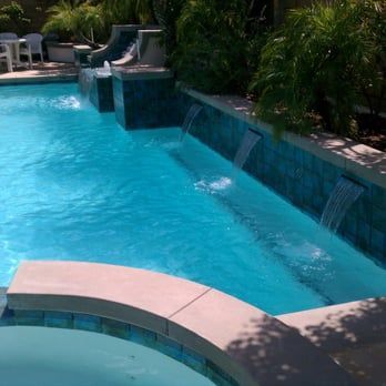 Swimming pool with waterfalls and blue water.