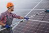 man cleaning solar panels