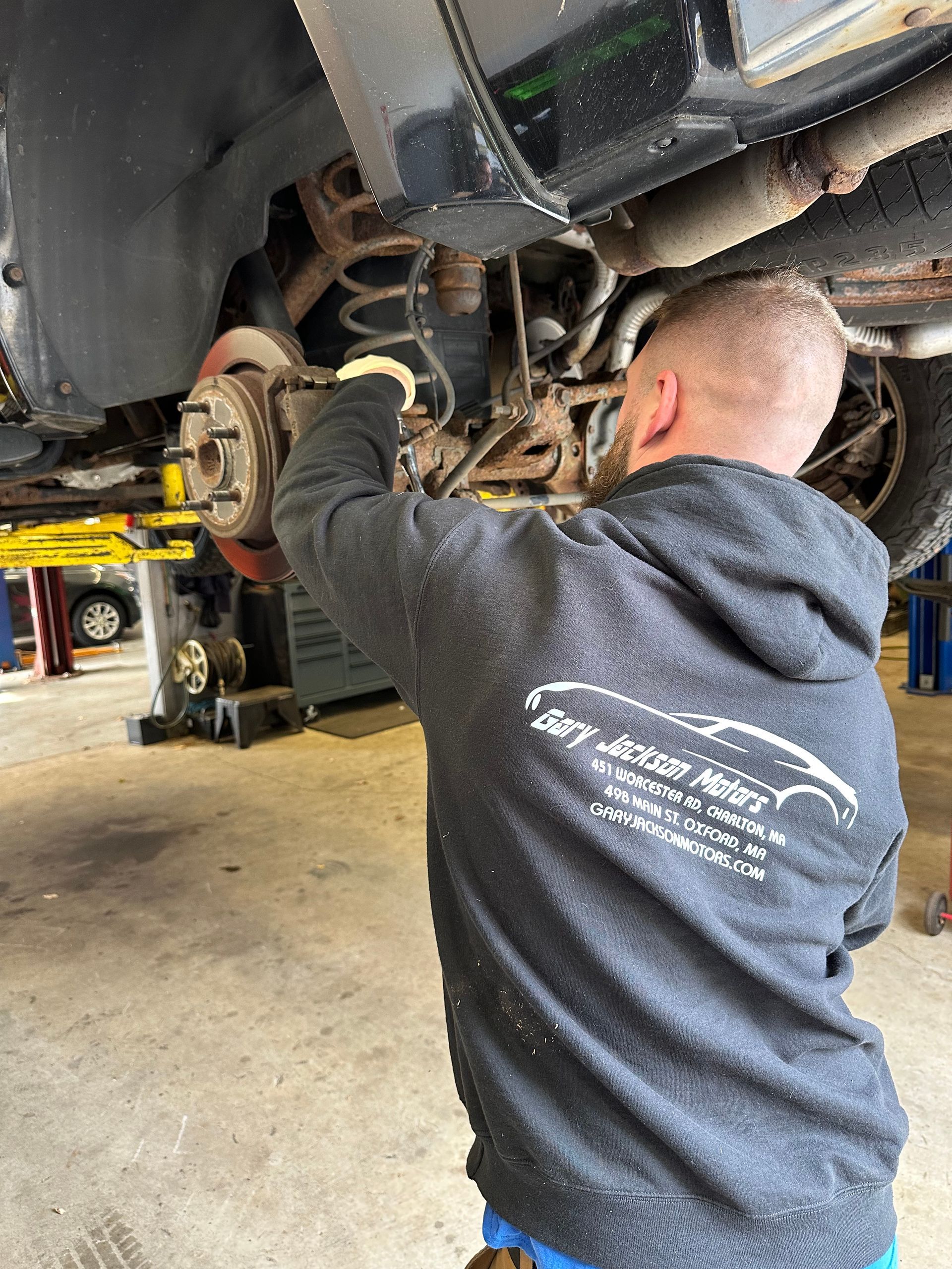 Mechanic Working on a Car's Undercarriage | Gary Jackson Motors