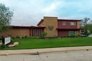 A church with rows of wooden benches and a podium