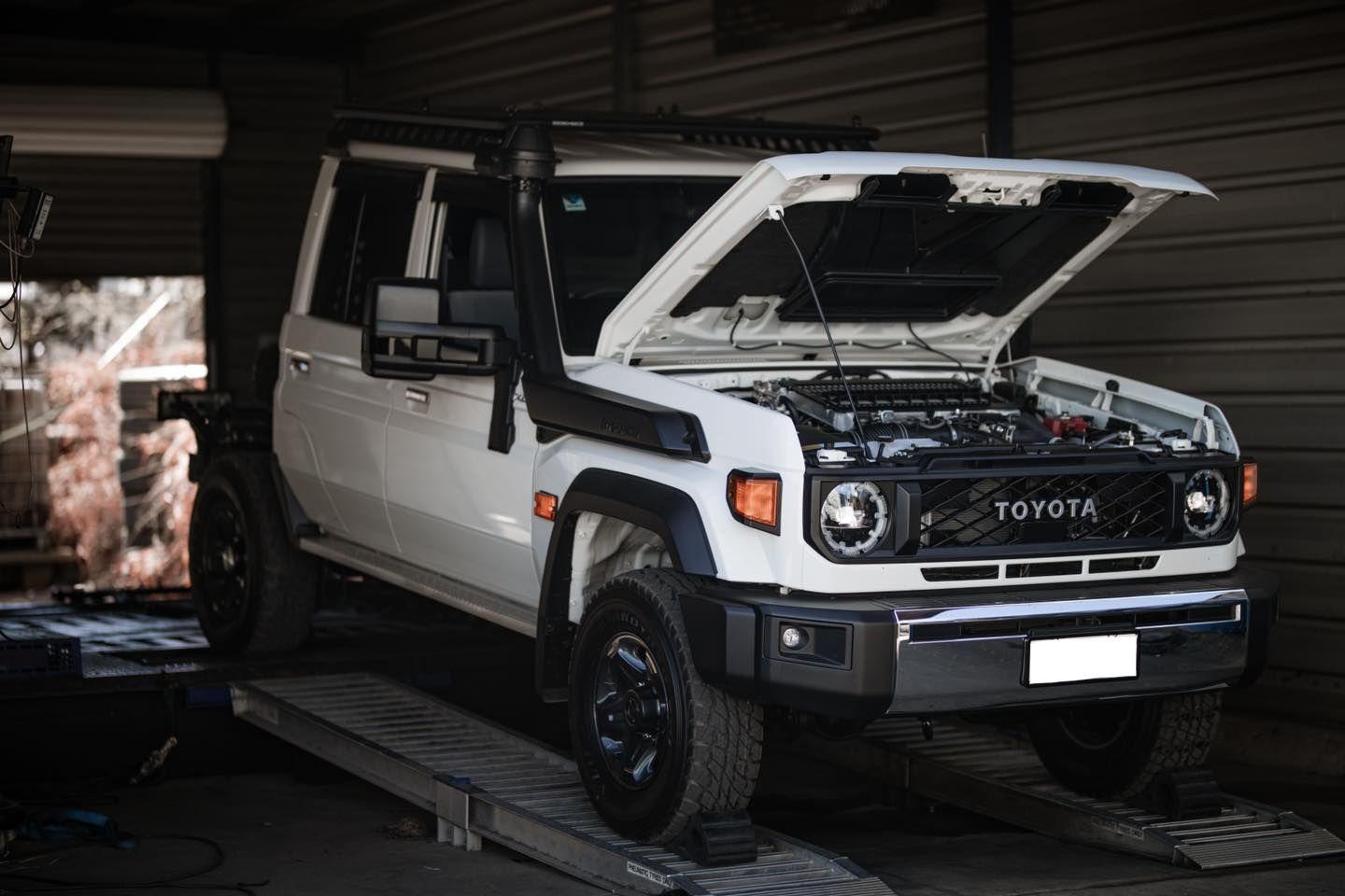 A White Toyota Land Cruiser With Its Hood Open Is Parked In A Garage — Dynolink In Garbutt, QLD
