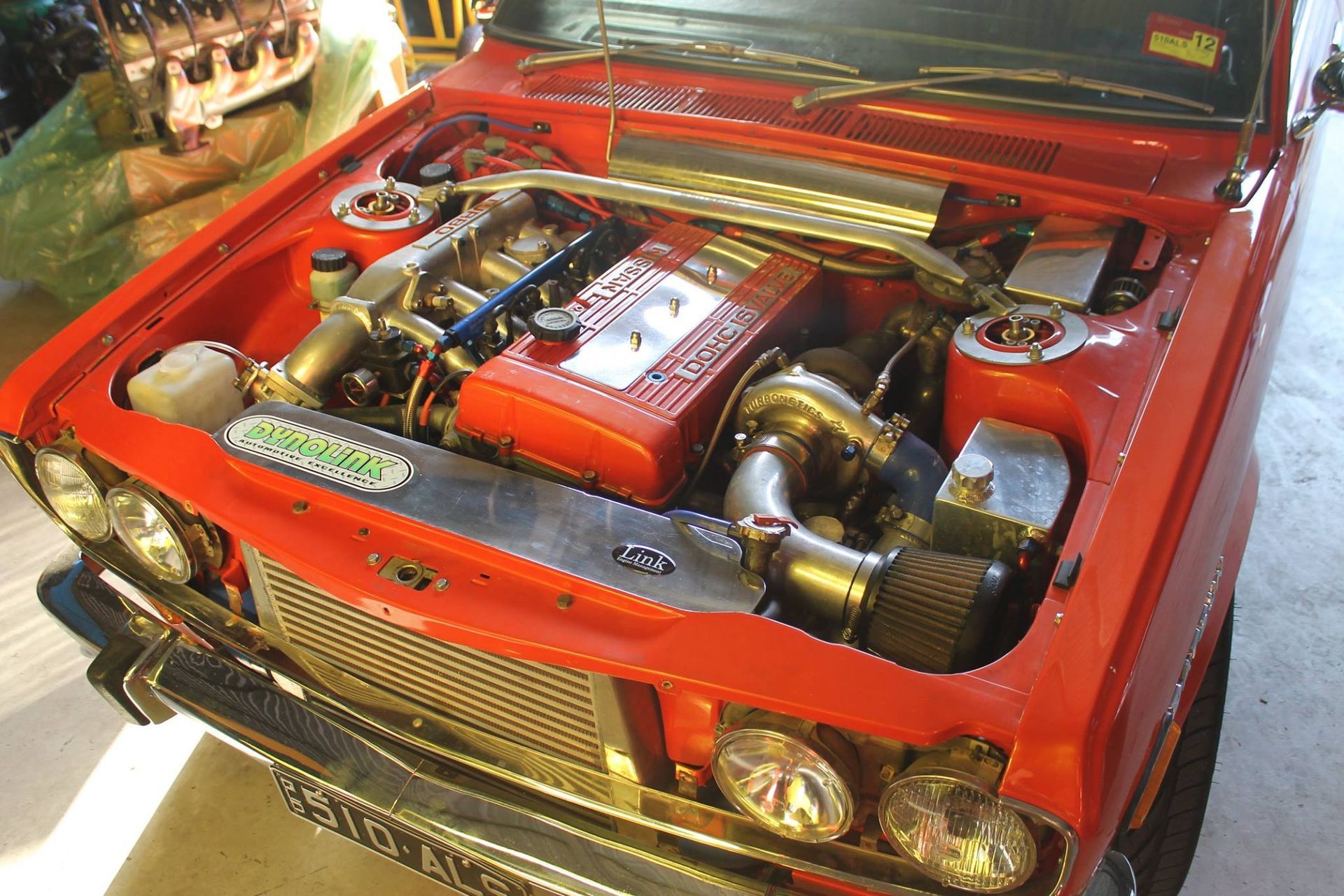 An Orange Car With Engine Showing — Dynolink In Garbutt, QLD