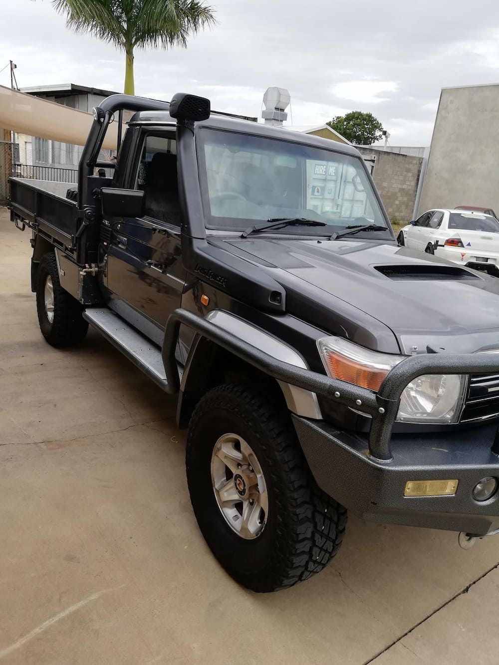 A Black Truck Is Parked In A Parking Lot Next To A Building — Dynolink In Garbutt, QLD