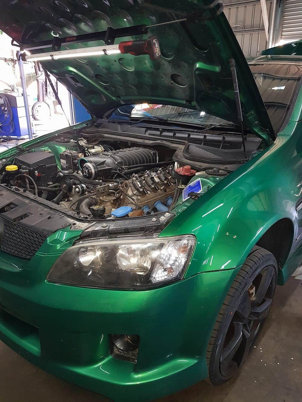 A Green Car With The Hood Open In A Garage — Dynolink In Garbutt, QLD