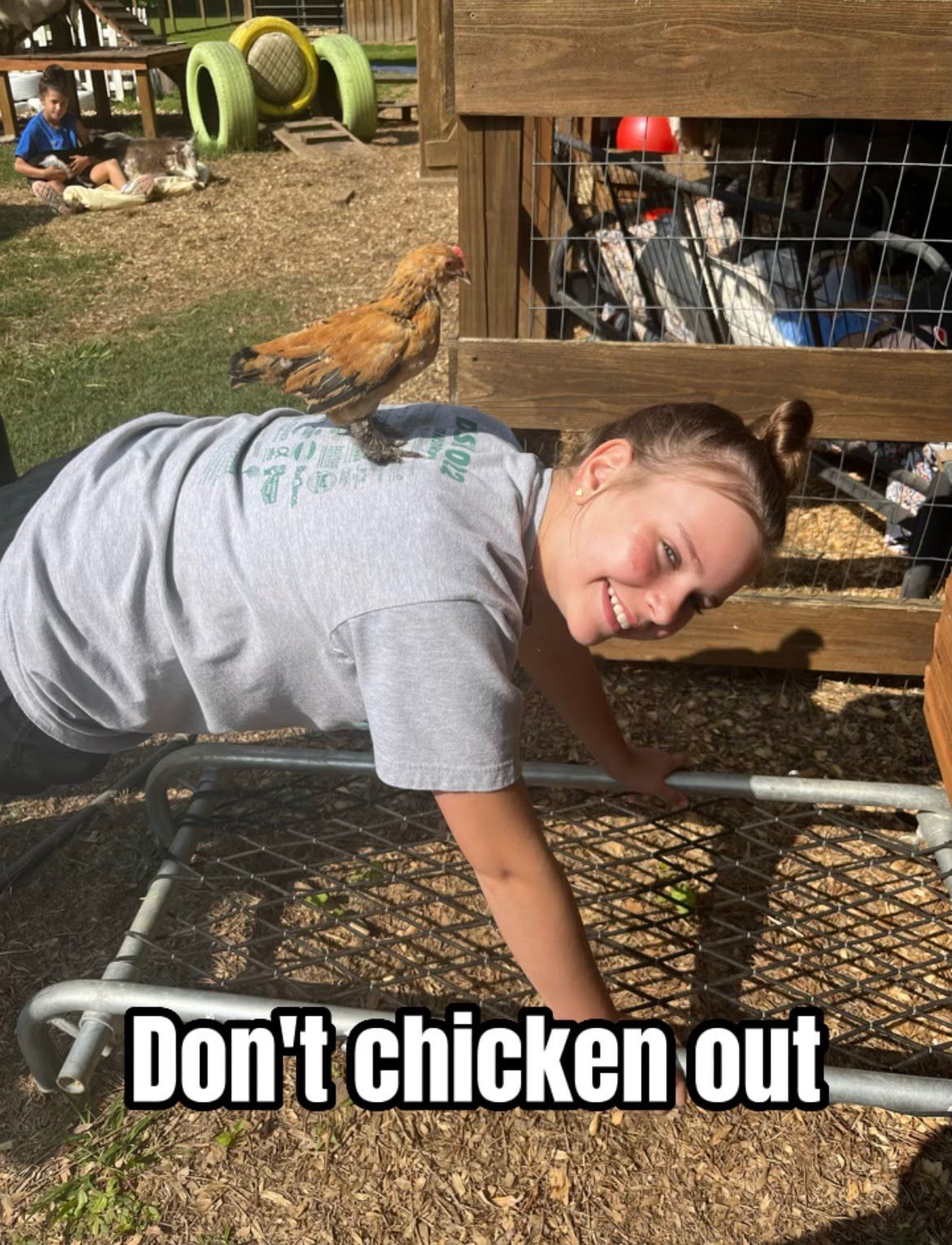 A woman is doing push ups with a chicken sitting on her back.