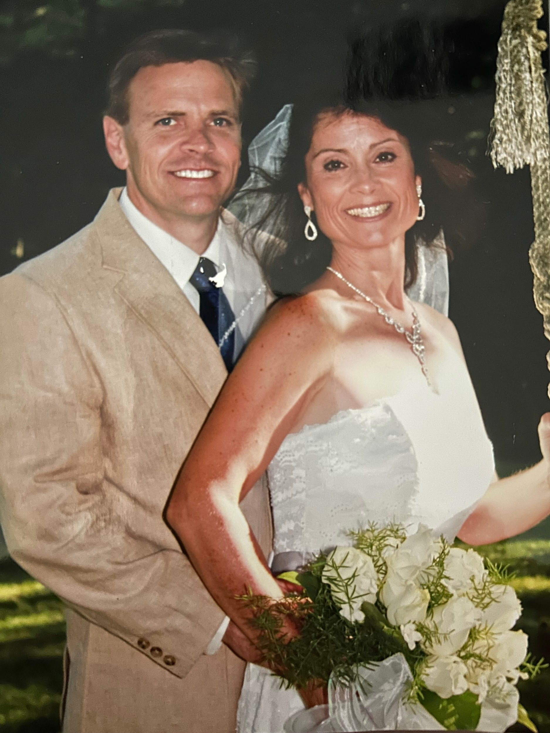 A bride and groom pose for a picture on their wedding day