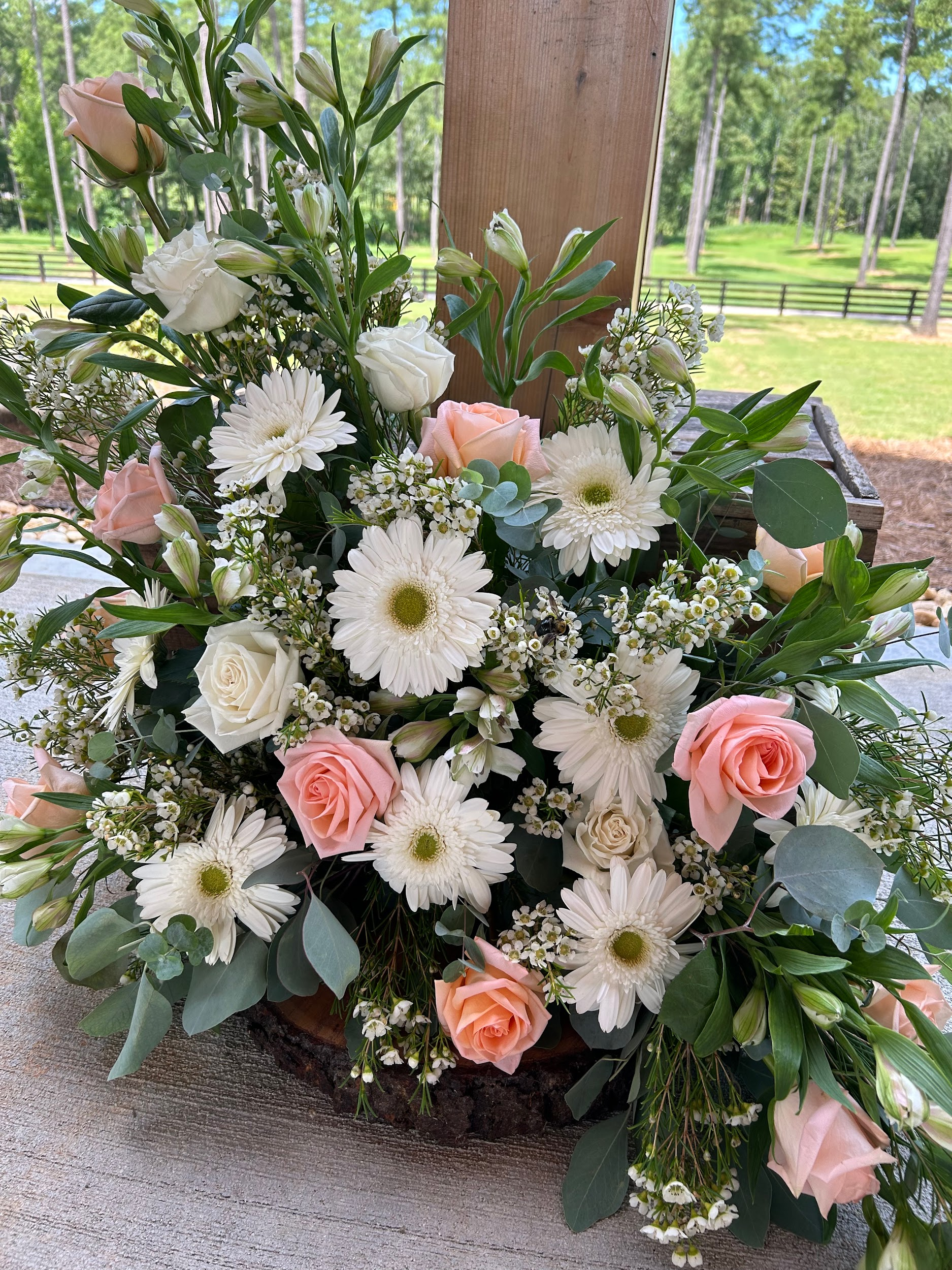 A large bouquet of white and pink flowers is sitting on a table.