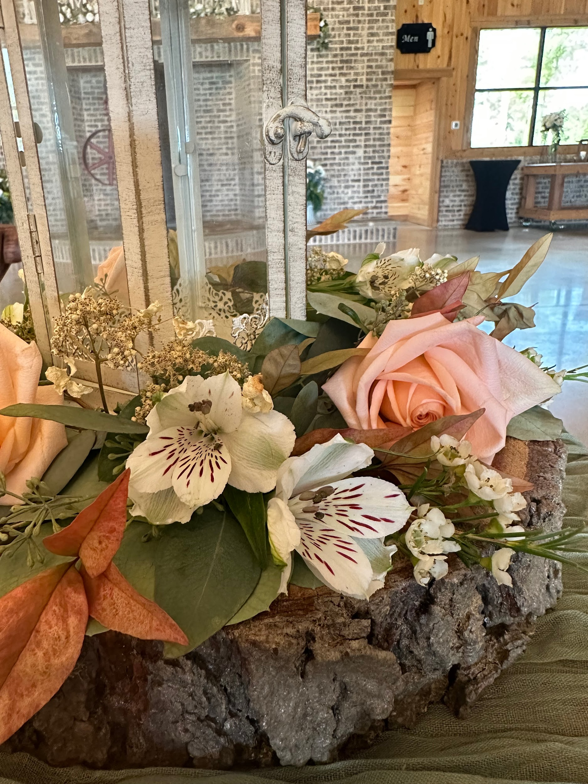 A bunch of flowers are sitting on top of a piece of wood.