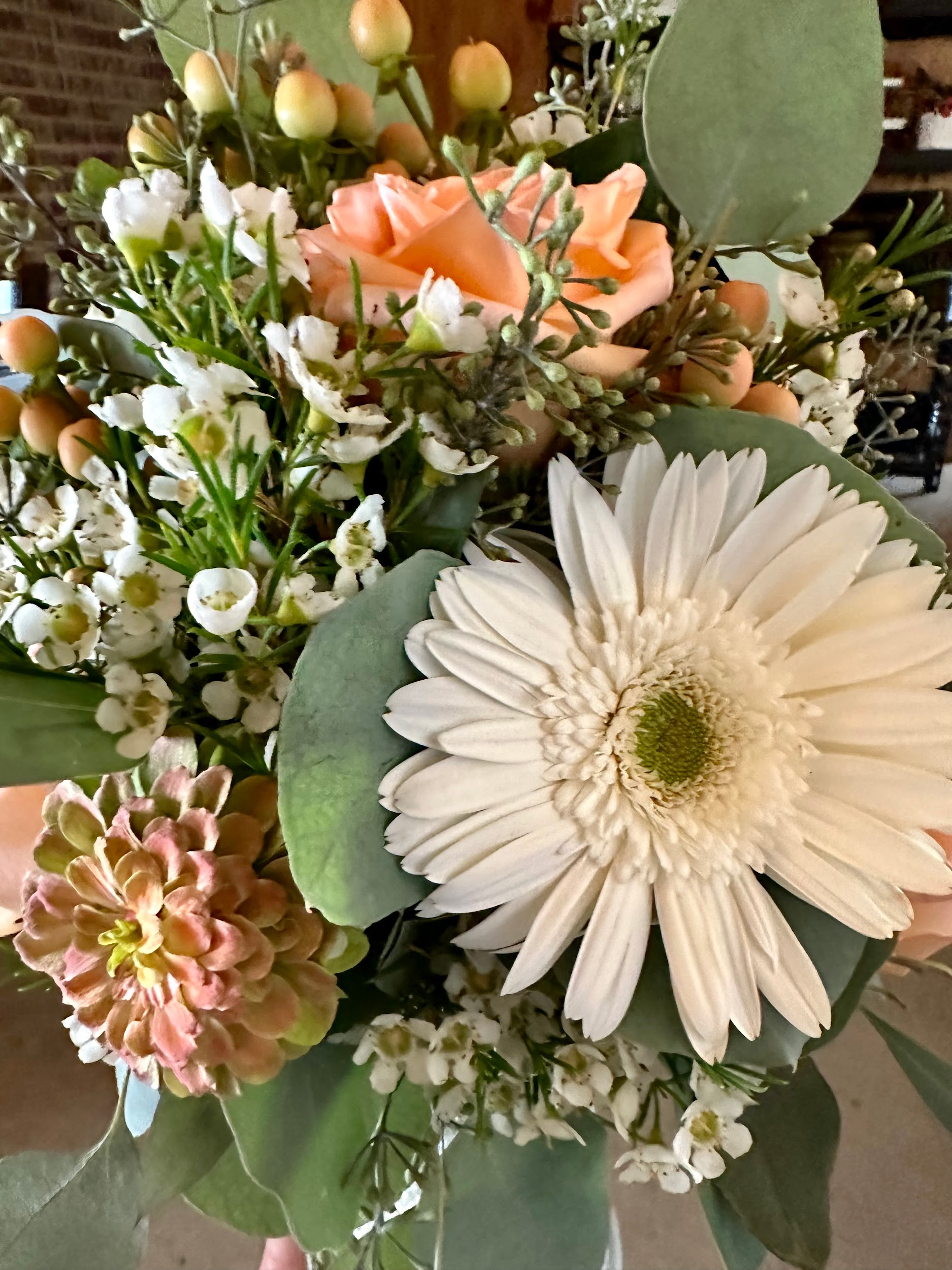 A person is holding a bouquet of flowers in their hands.