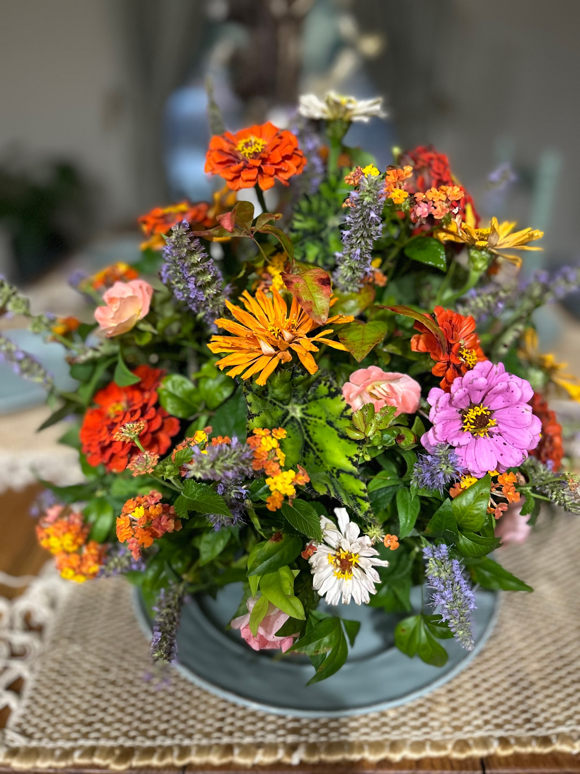 A vase filled with colorful flowers is sitting on a table.