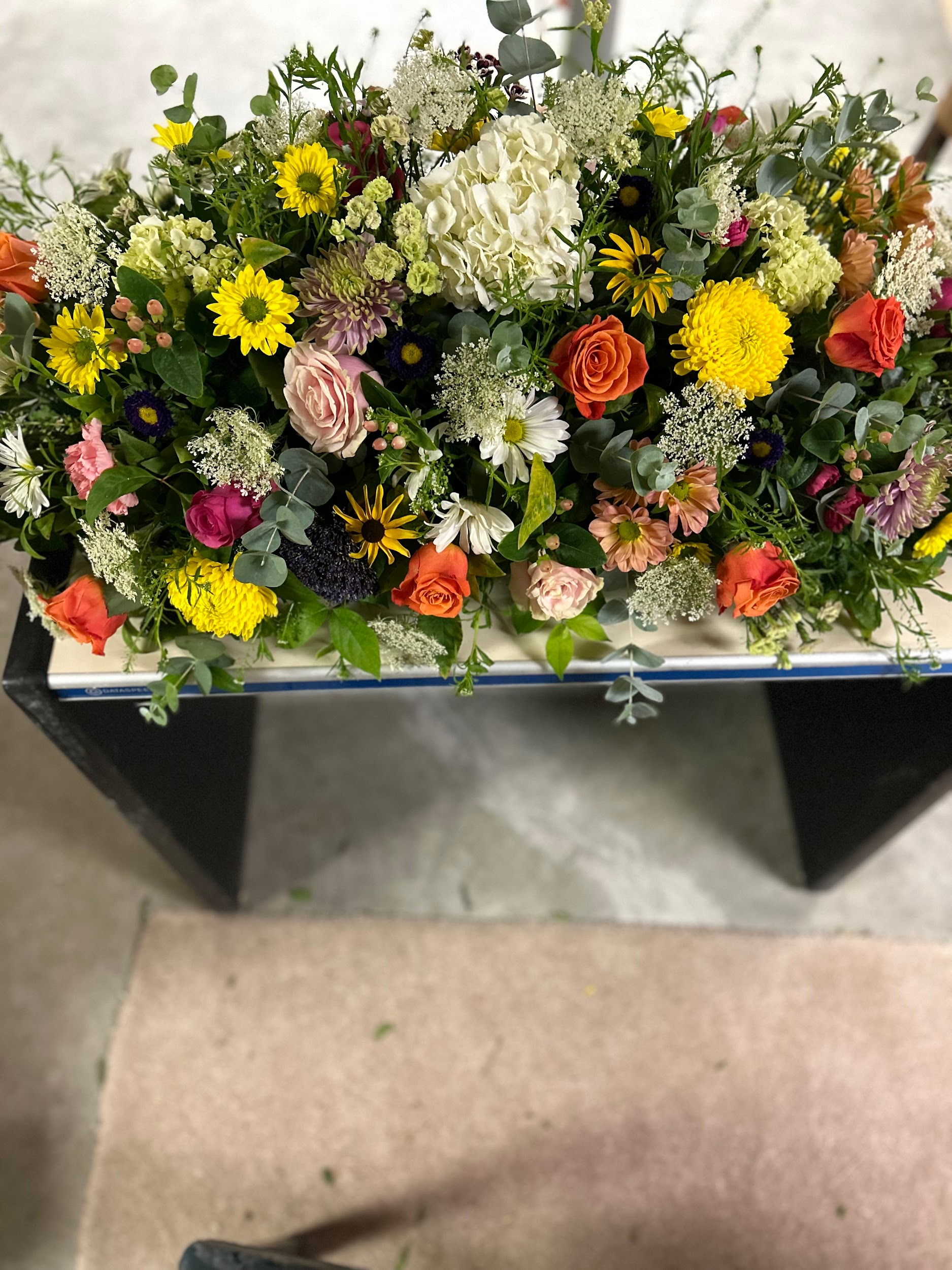 A bunch of flowers are sitting on top of a table.