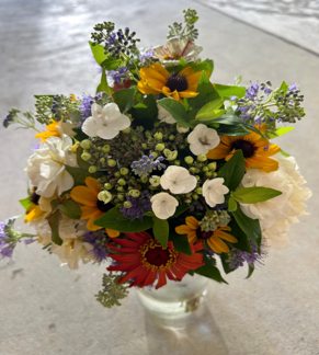 A woman is holding a bouquet of flowers in her hands.