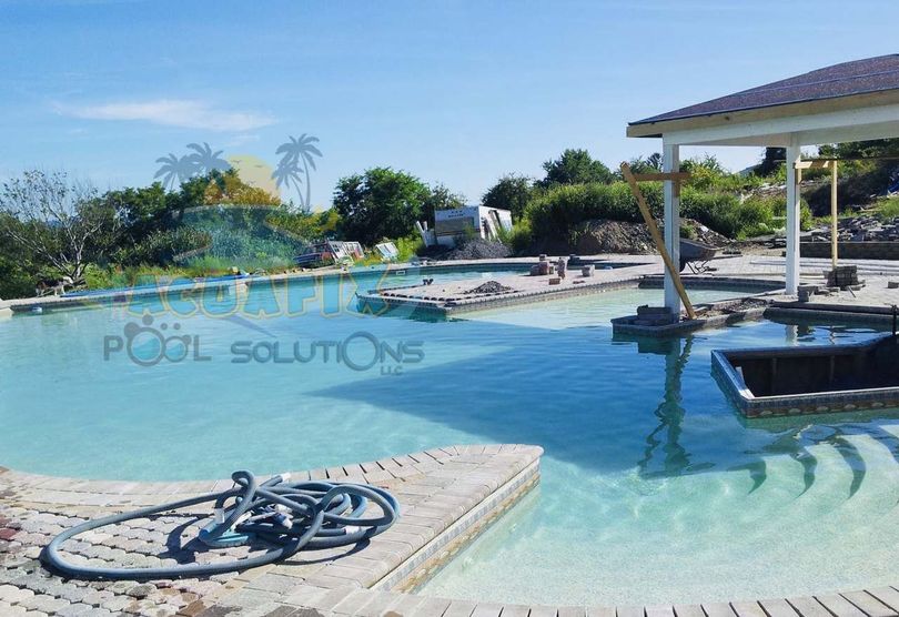 A large swimming pool with the words pool solutions on the bottom