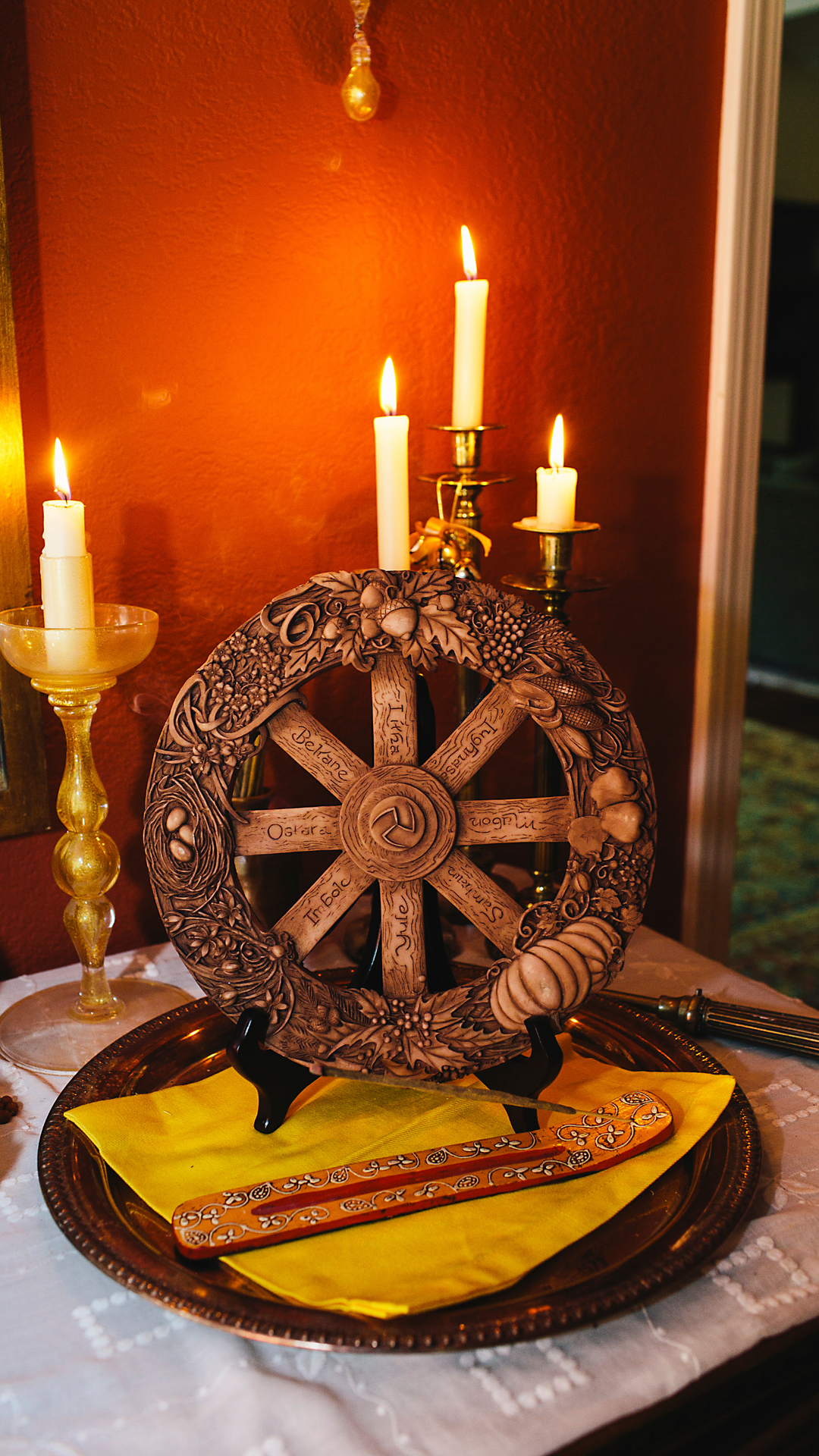 Candles and a wheel of the year carving