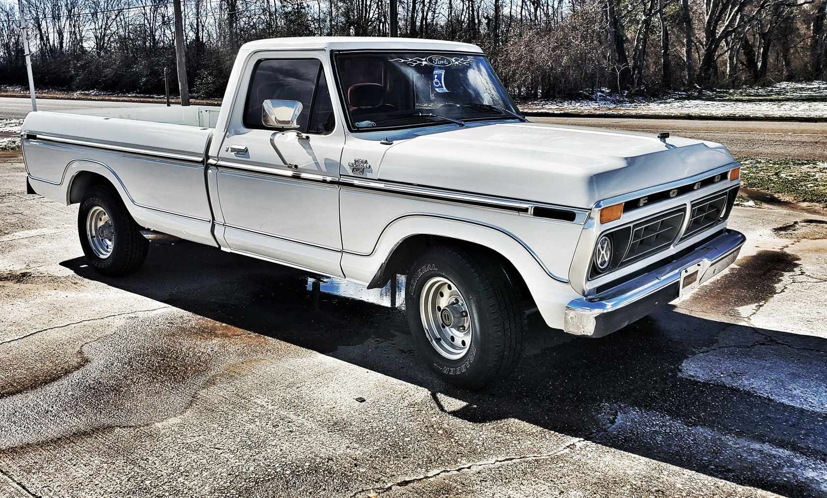 A white truck is parked on the side of the road