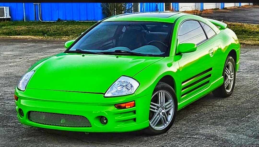 A bright green sports car is parked in a parking lot.
