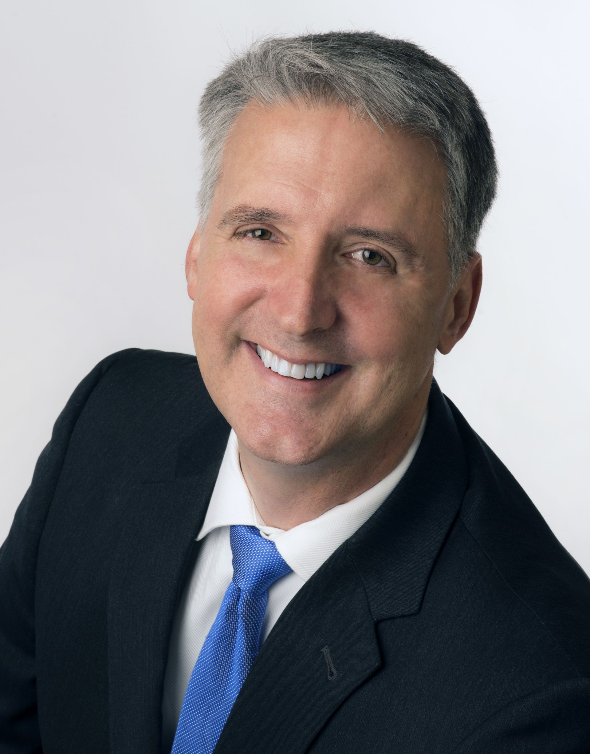 A man and a woman are posing for a picture and smiling