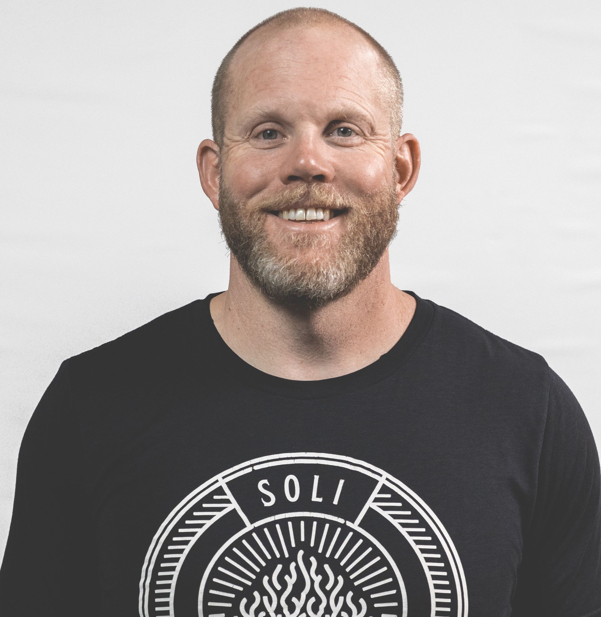 A man and a woman are posing for a picture and smiling