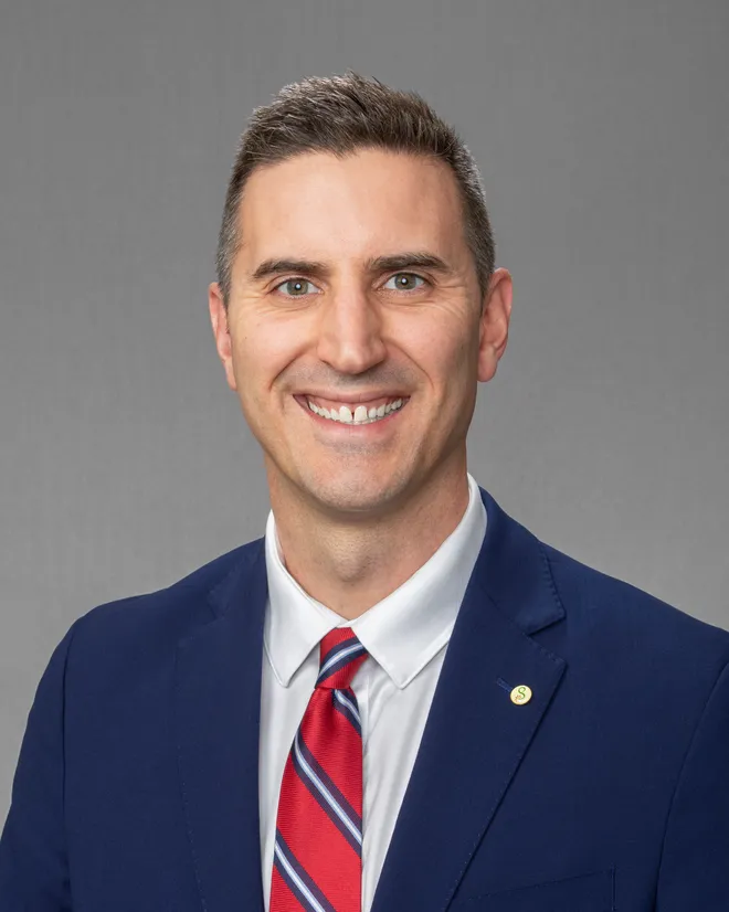 A man and a woman are posing for a picture and smiling