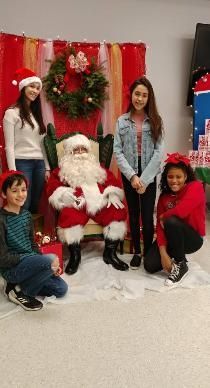 A group of children are posing for a picture with santa claus.