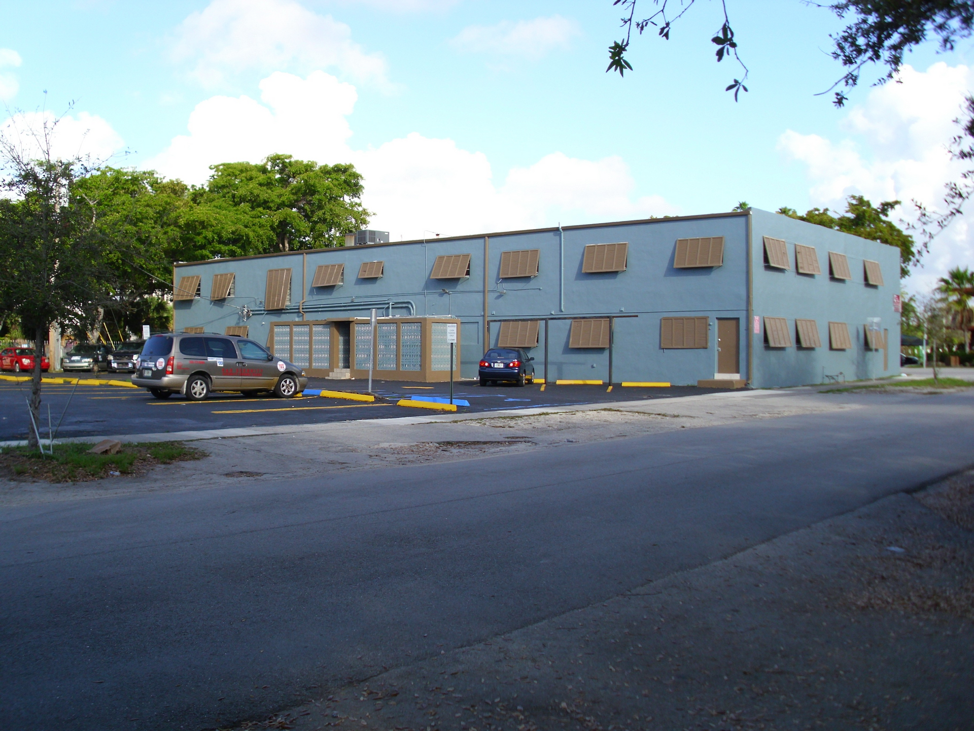 A blue building with cars parked in front of it