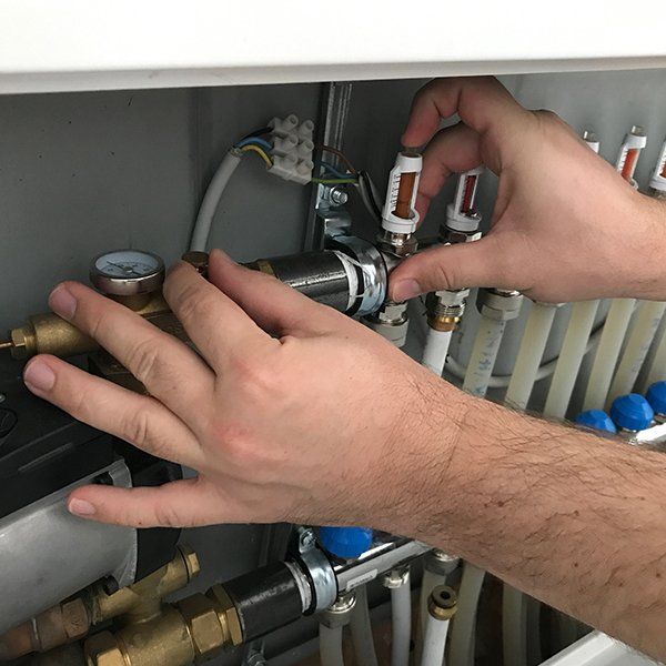 Man Checking and Adjusting Heating System Pipes — Jonesborough, TN — Newman Air