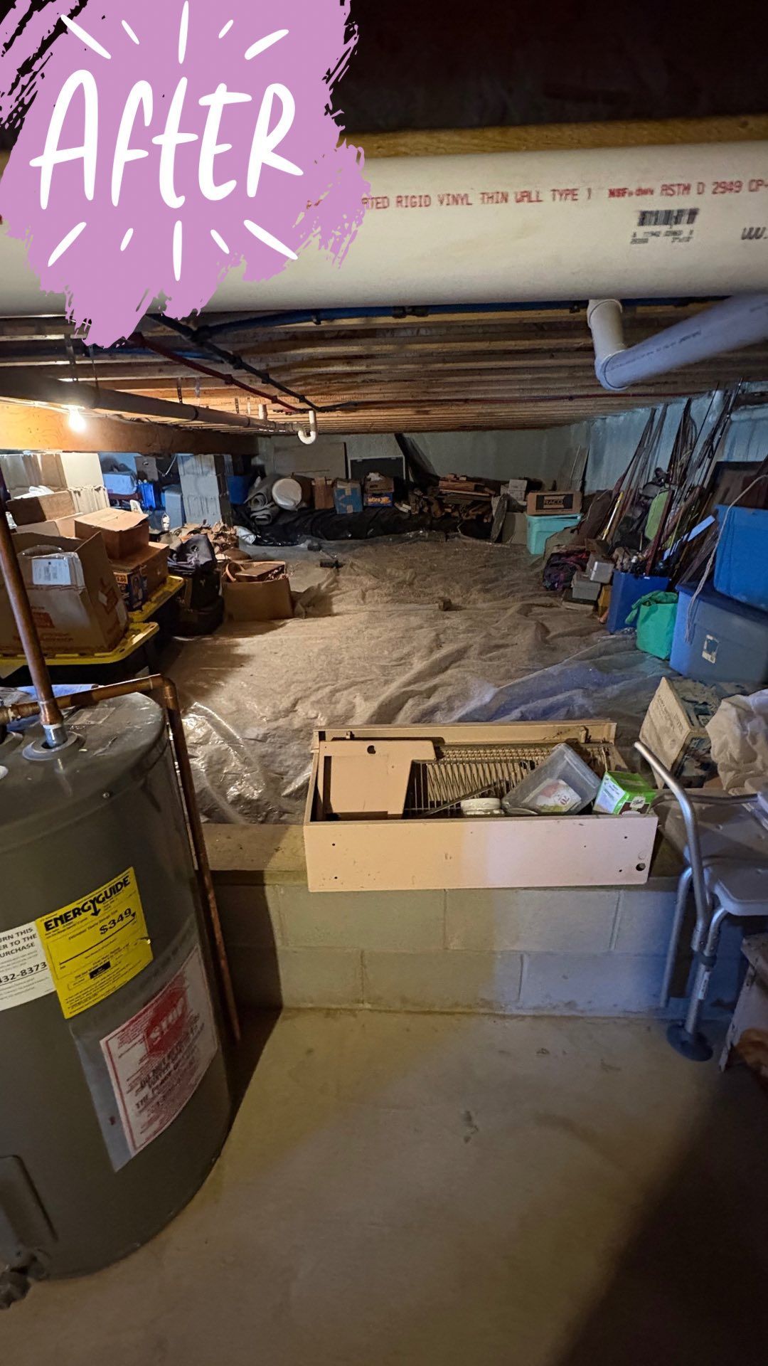 Cluttered basement storage area with water heater, cinder block wall, and exposed ceiling beams.