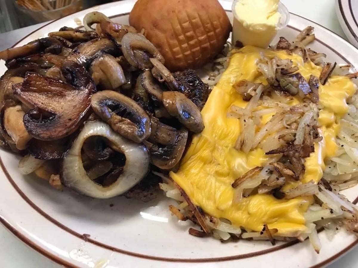 A plate of food with mushrooms eggs and hash browns