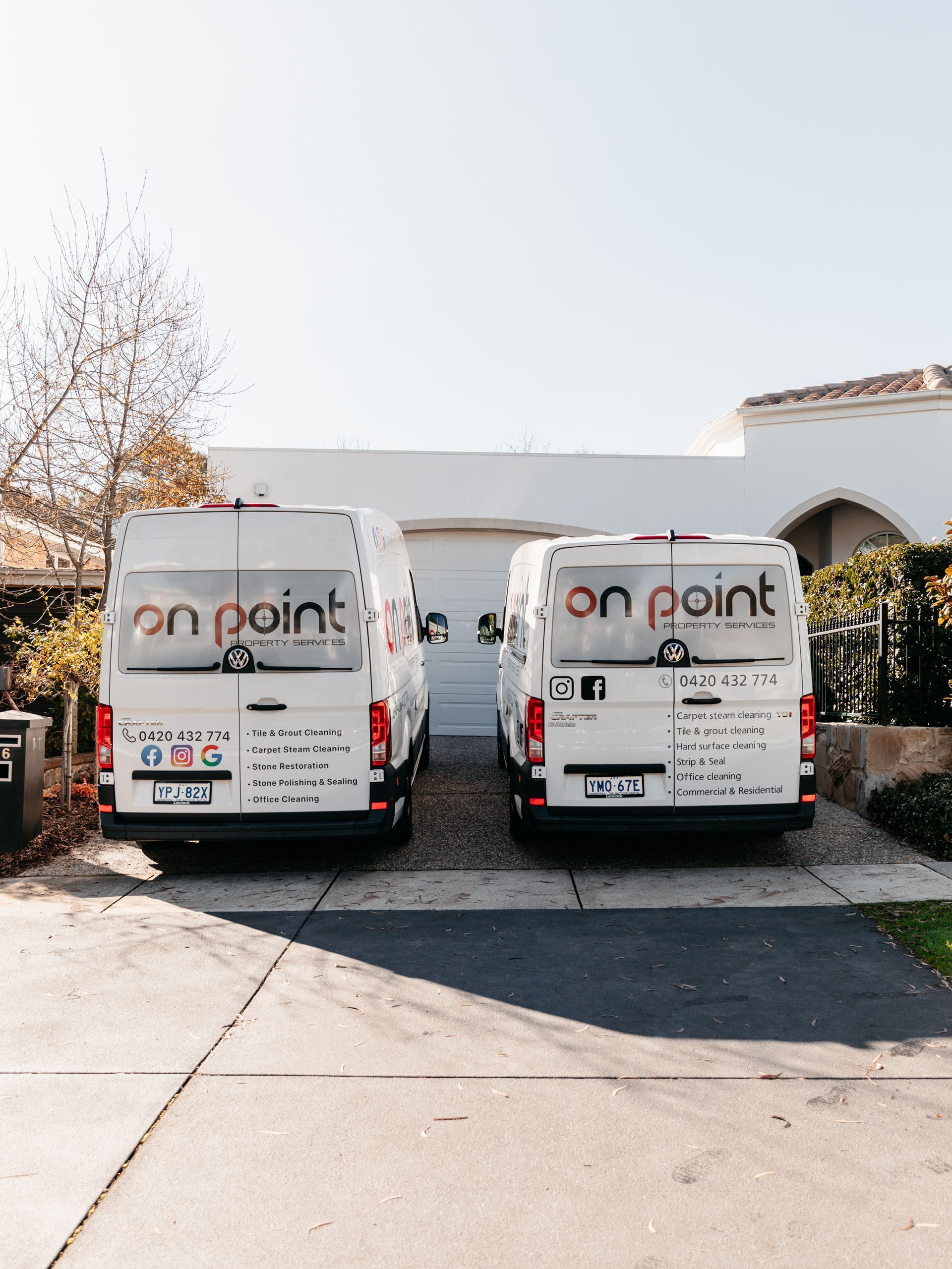 Two on point vans are parked in front of a house