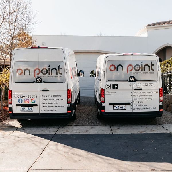 Two on point vans are parked in a driveway