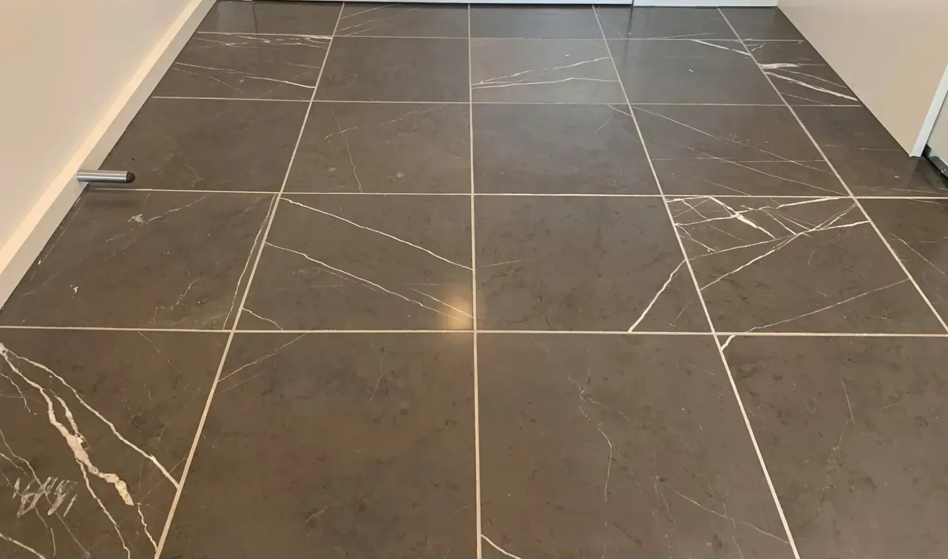 A close up of a tiled floor in a room.