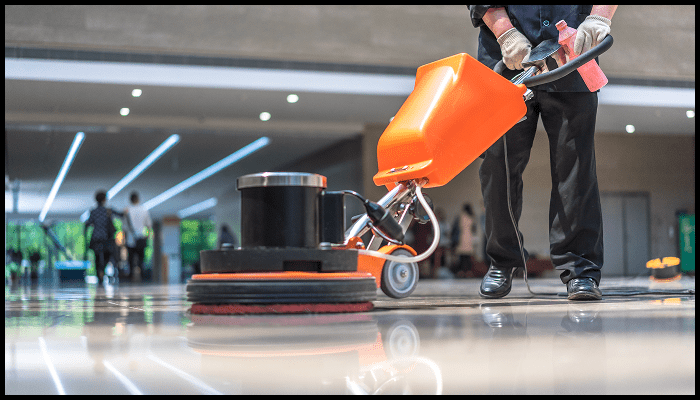 Professional polishing a marble floor with a floor machine, restoring its smoothness and reflective shine as part of the marble restoration process