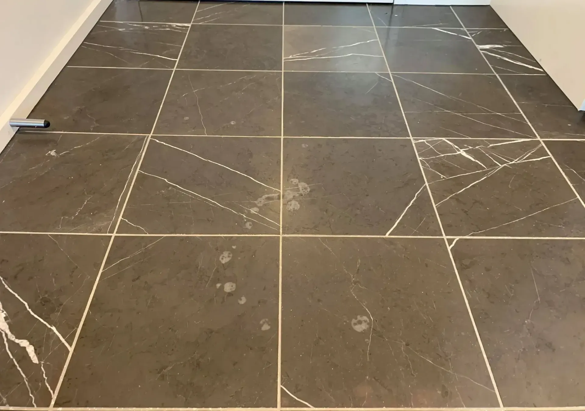 A black tile floor with white lines on it