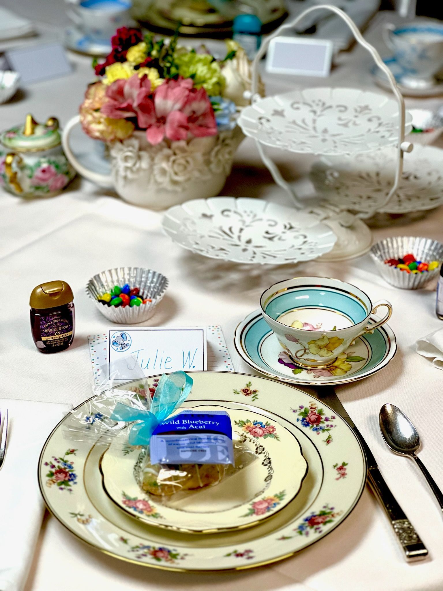 A table set for a tea party with plates, cups, and saucers.