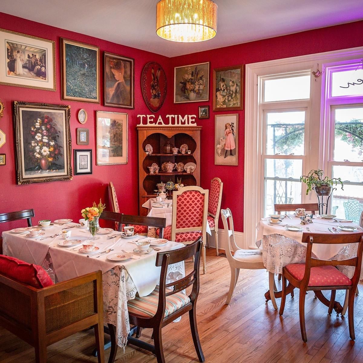 A room with red walls and a sign that says teatime.