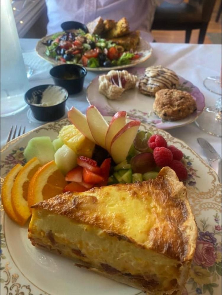 A plate of food with a slice of pie and fruit on it.