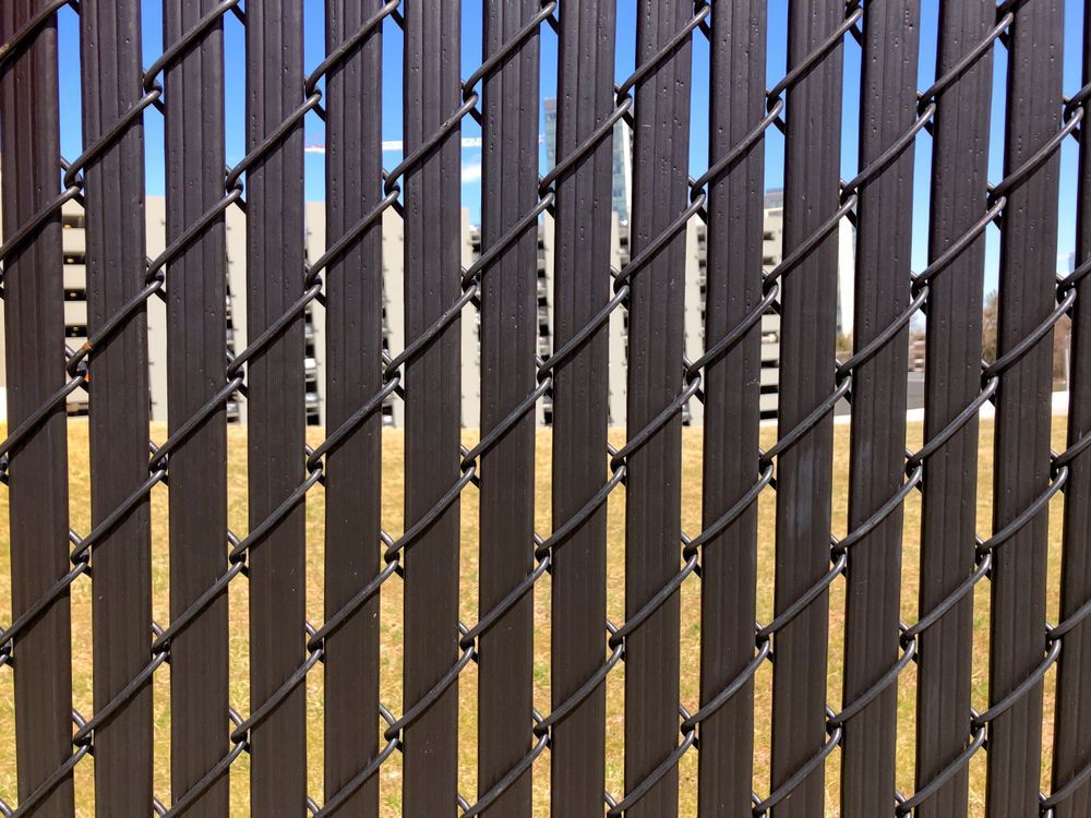 A Close Up of a Chain Link Fence With a Blue Sky in the Background — Febos Welding and Engineering In Corrimal, NSW
