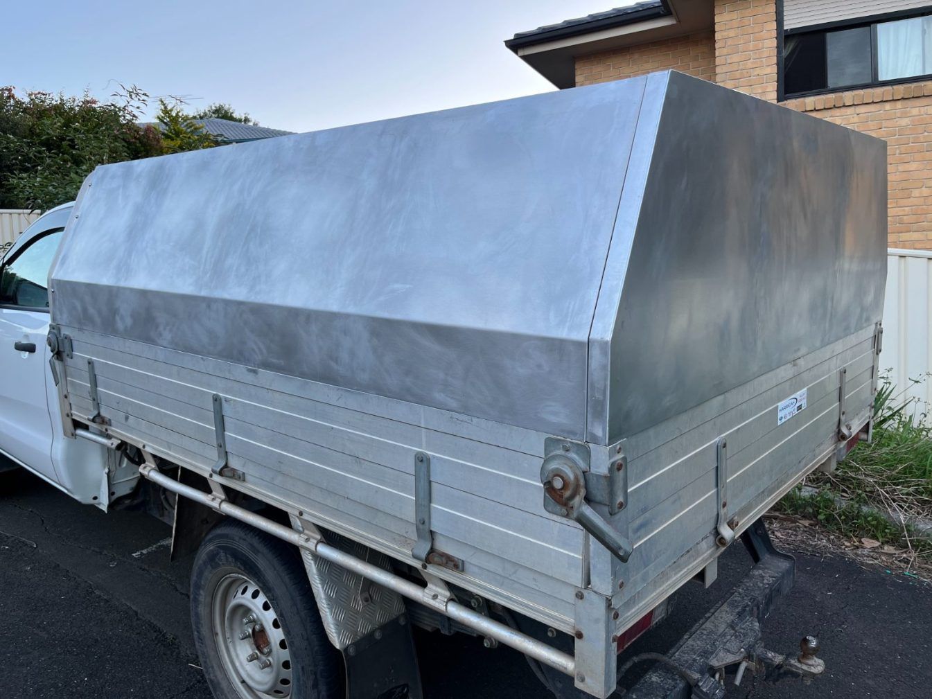 A Silver Truck With a Canopy on the Back is Parked on the Side of the Road — Febos Welding and Engineering In Corrimal, NSW