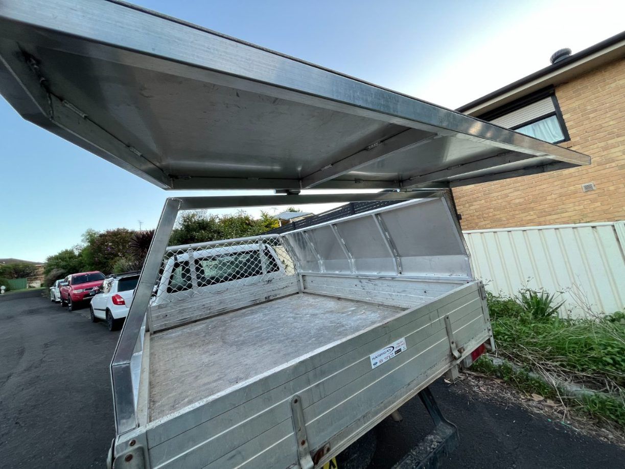 A Truck With a Canopy on Top of It is Parked on the Side of the Road — Febos Welding and Engineering In Corrimal, NSW