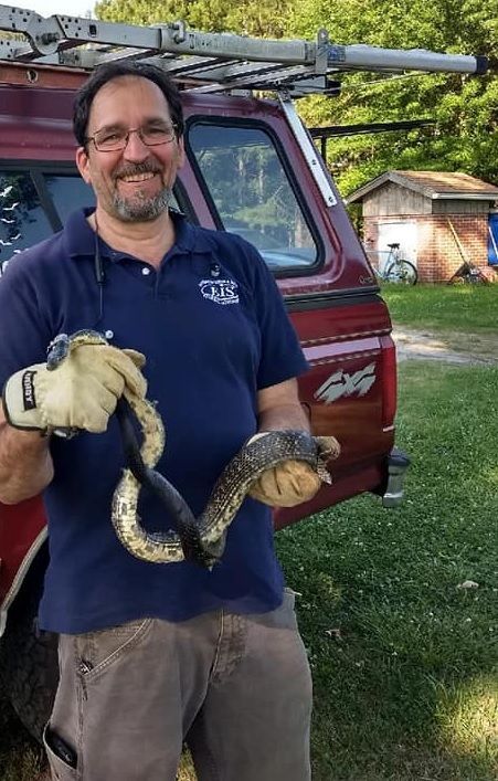 Man Holding A Snake — Greensboro, NC — The Critter Gitter LLC
