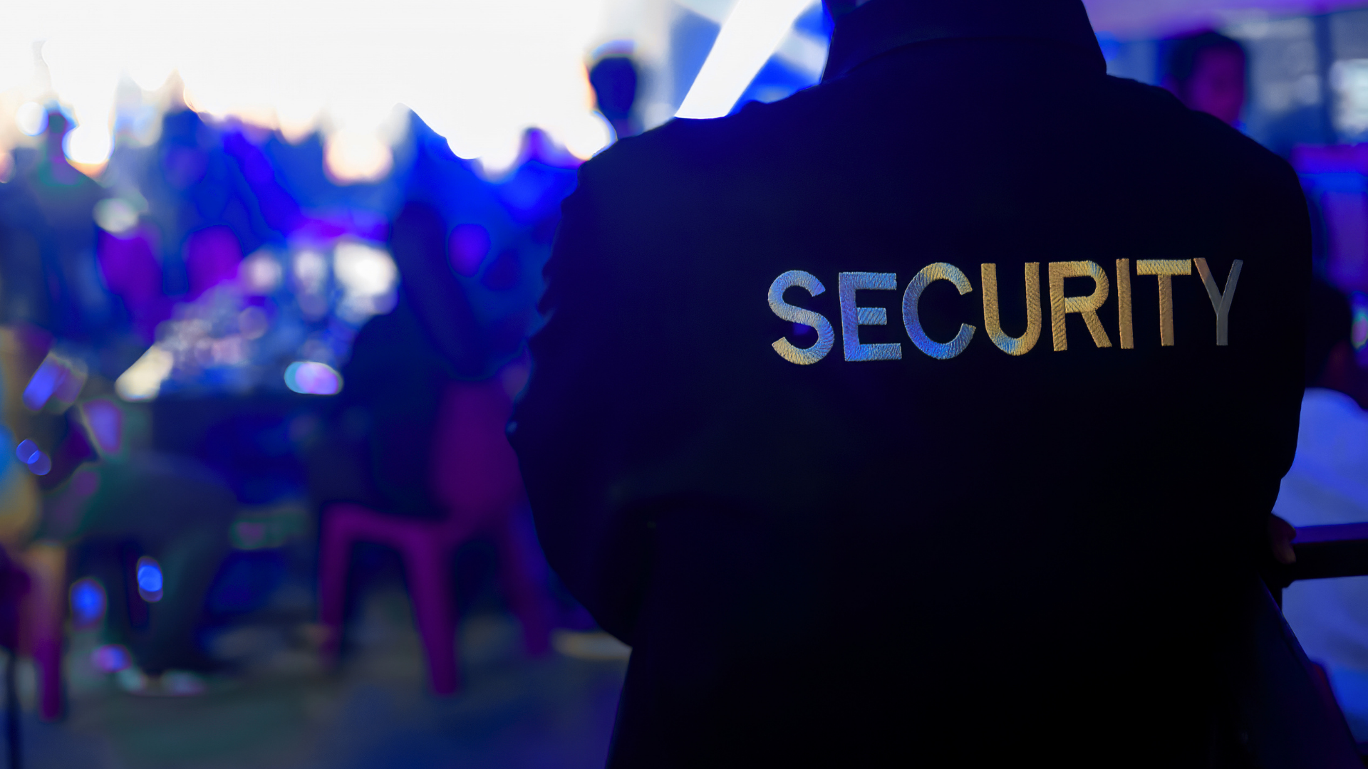 A security guard in a black uniform with 