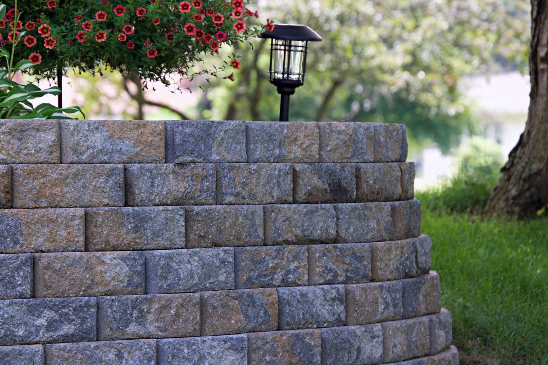 Retaining Wall with Light and Flower — Pasco, WA — Jeff's Lawn Care & Landscaping LLC