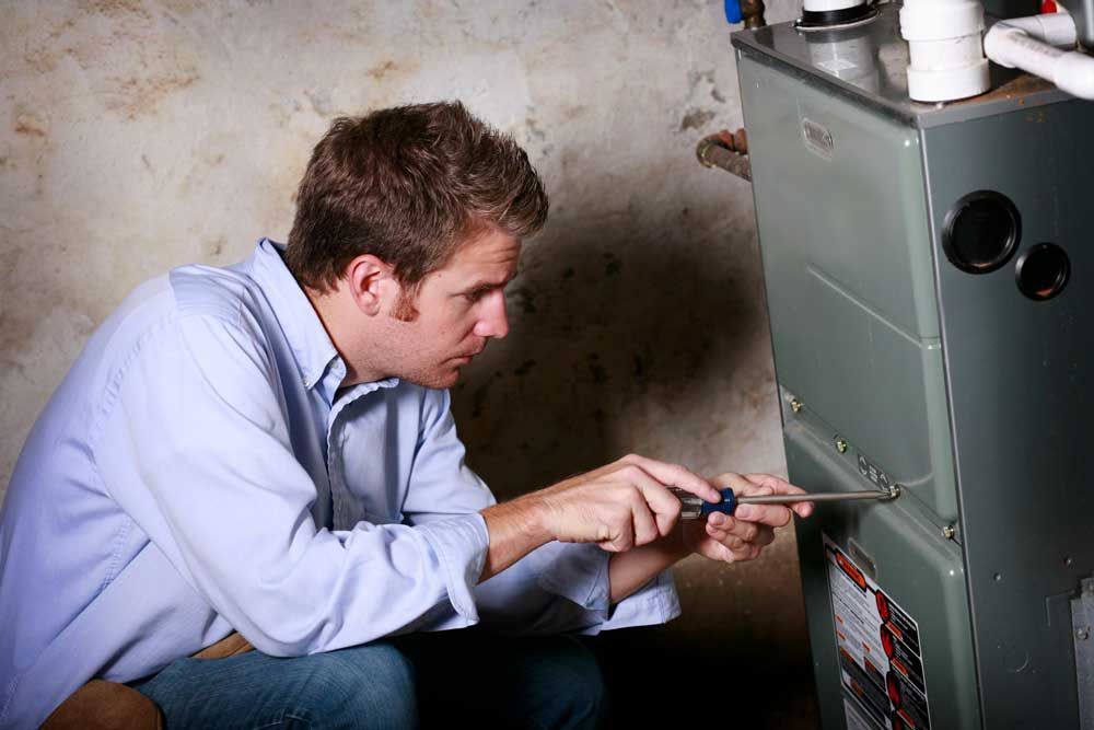 Man Installing Room Heater — Port Charlotte, FL — Air Technicians Inc